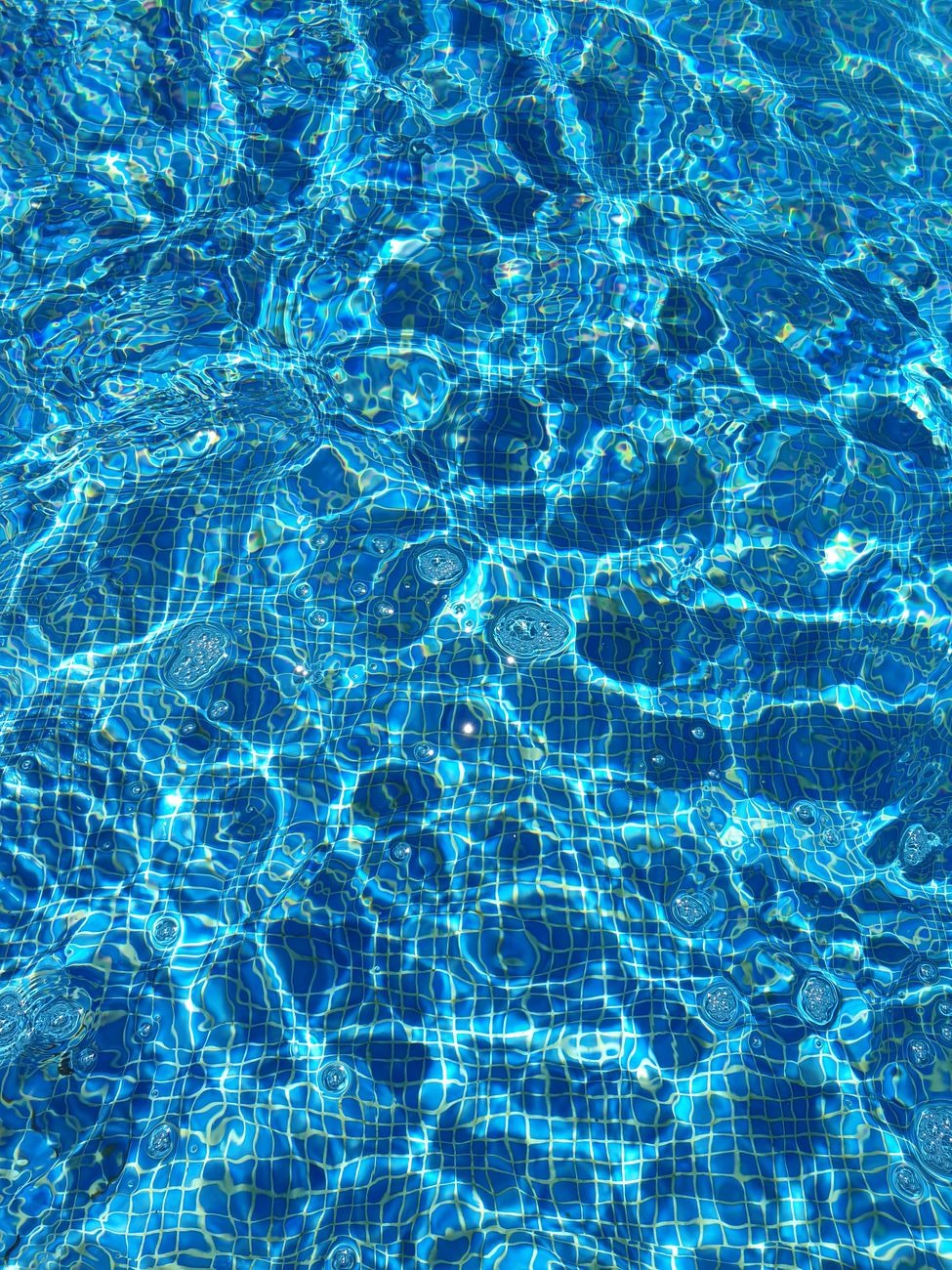Pool skimmer and cleaning tools in action